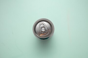 Closeup top view of a metal can on a blue surface