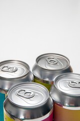 Vertical closeup view of four metal beverage cans