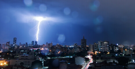 Thunderstorm with lightning in a cloudy sky over the high buildings of city SANTA CRUZ DE LA SIERRA - BOLIVIA 