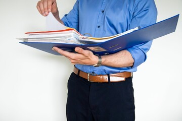 Businessman holding a blue paper holder and pointing to something in it