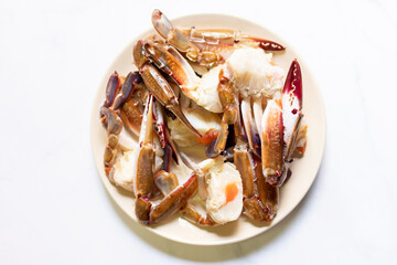 Fresh blue crab legs on plate preparing to delicious seafood meal.