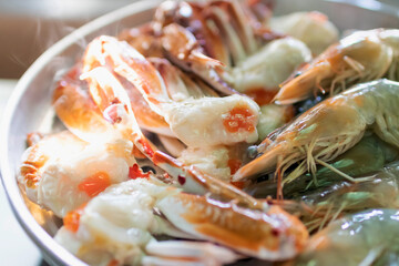 Steam blue crab legs and shrimp on food steamer.