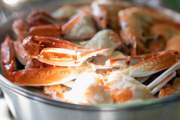 Steam blue crab legs and shrimp on food steamer.
