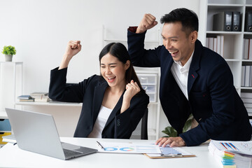 Successful business team celebrating together after receive the good news.