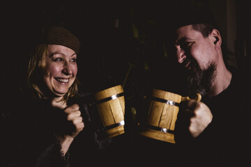 two people toasting with their jugs