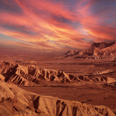 Sunrise over rocky desert and distant mountains in the wild. Wonderful world. Environment protection