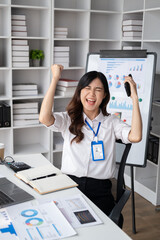 Successful young businesswoman celebrate her victory at the modern office room. Business achievement concept .