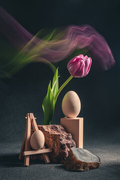 concept spring. freakebana. Trendy card with purple tulip and Easter eggs. easter concept. Creative image of flowers with blurred trail, fantasy motion effect, motion blur