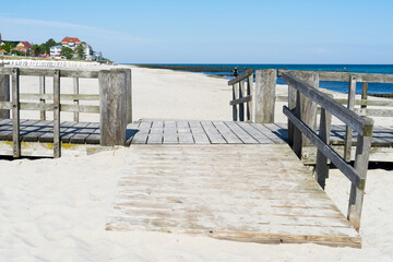 Fototapeta na wymiar Bathing jetty on the Baltic Sea on a sunny summer day. The sea and the sky are wonderfully blue