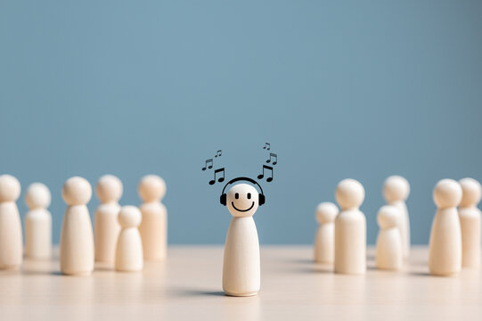 Individuality, Unique or Introvert Person. Person who Happy and Enjoy by isolation. Wooden figure with happy face by listen music alone among crowd. Psychology Personality. Separation or Solitude.