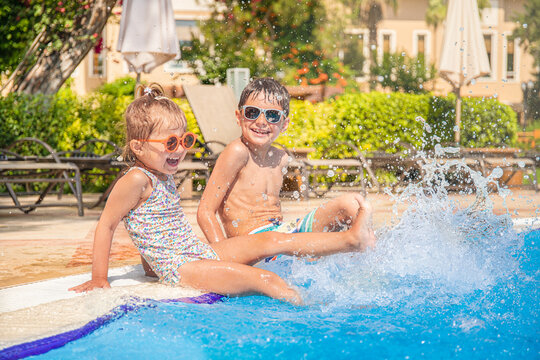 Children splashing by swimming pool
Fun in the pool
two children playing near the pool