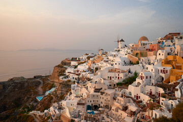 sunset over Oia village, Santorini island with Aegan sea, Greece