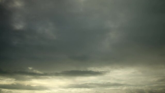 Gray depressing pre-storm clouds are moving rapidly in the sky, video timelapse, sky as a background.