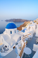 traditional greek village Oia of Santorini, with blue domes of churches and village roofs, Greece