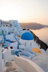 traditional greek village Oia of Santorini, with blue domes of churches and village roofs, Greece