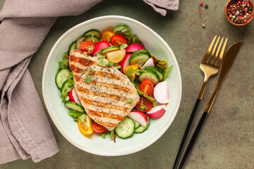 Juicy pork steak grill with vegetables in a plate on the table. Top view