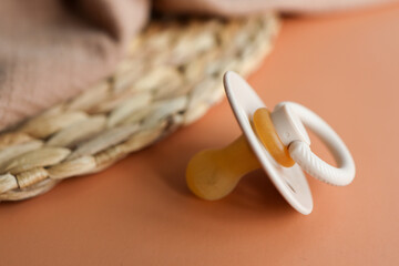 Baby pacifier close-up on a beige background