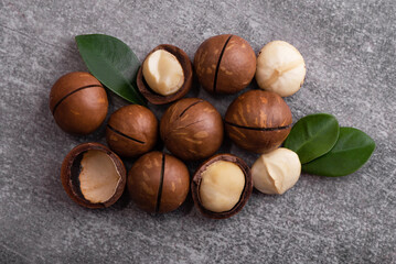 Organic Macadamia nut in wooden bowl and spoon. Superfood and healthy food concept.