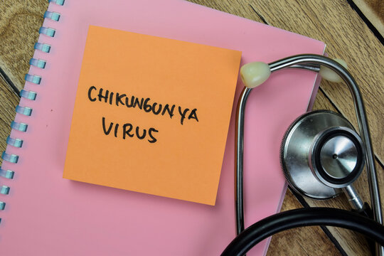 Concept of Chikungunya Virus write on sticky notes with stethoscope isolated on Wooden Table.