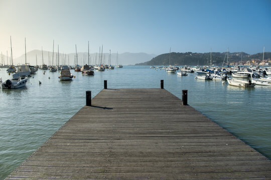 Wooden dock and boats anchored in Golfo dei Poeti, (Gulf of Poets), Lerici, La Spezia, Liguria, Italy