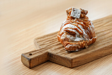 Delicious banana croissant on a wooden board