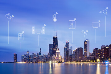 Illustrations of smart devices (internet of things) over city skyline at night, Chicago, Illinois, USA