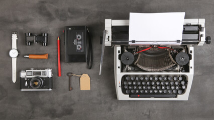 Fototapeta na wymiar vintage typewriter and tape recorder on the table with blank paper on the desk - concept for writing, journalism, blogging
