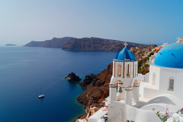 traditional greek village Oia of Santorini, with blue domes and white walls against sea and caldera, Greece