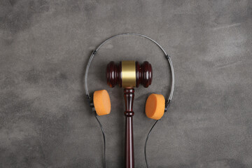 Music piracy and copyright protection law concept, gavel, tape recorder and headphones on table - 592375599
