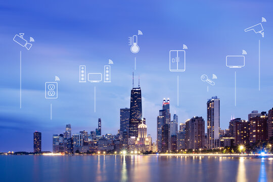 Illustrations of smart devices (internet of things) over city skyline at night, Chicago, Illinois, USA