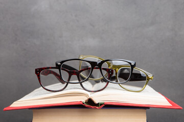 Eye care concept - classic fashion eyeglasses on grey background