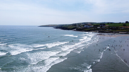 Many Irish on the beach of Inchydoney on a summer day, top view. Seaside Irish landscape. The Coast Of The Atlantic Ocean.