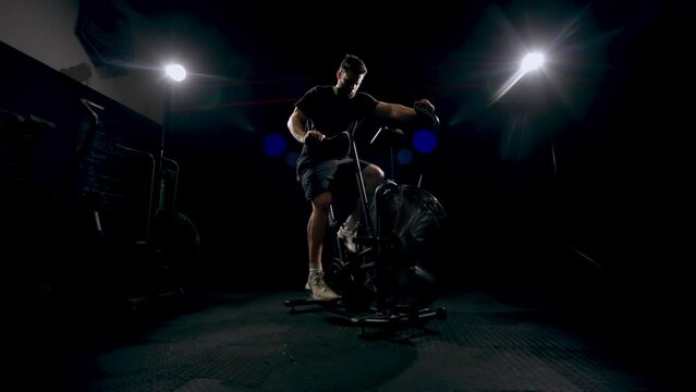 Man doing fitness training on bike at gym, workout for sports motivation and cardio exercise for strong body. Face of person with testosterone getting healthy and moving for wellness and health