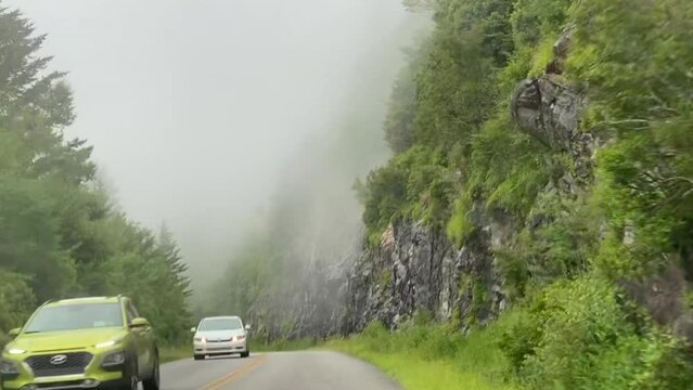 A foggy drive on the Blue Ridge Parkway near the Waterrock Knob and Balsam Gap area. Point of view (POV) of driving through a light rain. 