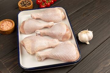 Raw chicken legs on a baking sheet