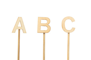 Individual wooden letters forming an ABC isolated on a white background
