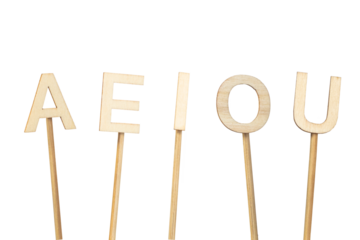 Single wooden vowels isolated on a green chroma background. A E I O U.