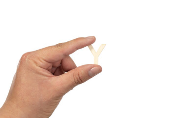 Unrecognizable person holding a letter y on a white background