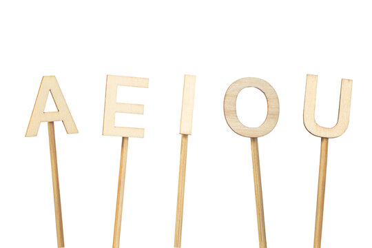 Single wooden vowels isolated on a green chroma background. A E I O U.