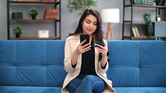 Beauty modern Asian woman paying card online shopping smartphone application buying goods remotely