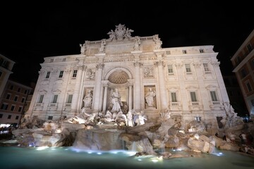 Night view of the Trevi Fountain under black sky in Rome, Italy