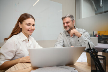 Young woman talking with man in the office