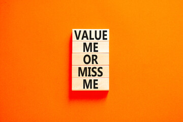 Value or miss me symbol. Concept words Value me or miss me on wooden block. Beautiful orange table orange background. Business psychological and value or miss me concept. Copy space.