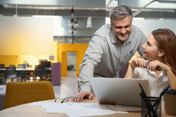 Male and female discussing work process in the office