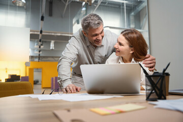 Woman and man happy for work results in the office