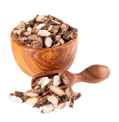 Calamus root in wooden bowl and spoon, isolated on white background. Sweet flag, sway or muskrat root. Dry root of Acorus calamus.