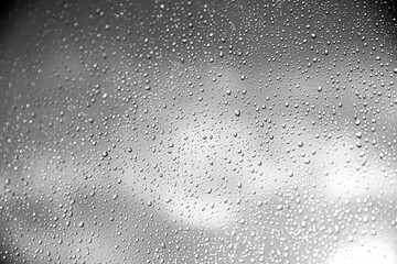 Greyscale shot of water drops on a glass