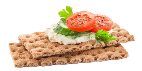 Two Slices of Crispbread with soft cottage cheese and slices of red tomatoes and cucumbers with