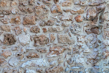 old stone wall made of sandstone blocks of different sizes as the background - 592389981