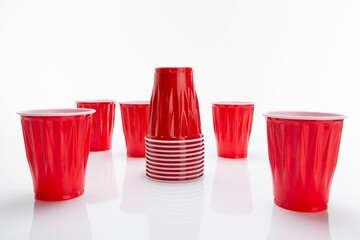 Stack of disposable red plastic cups isolated on a white background